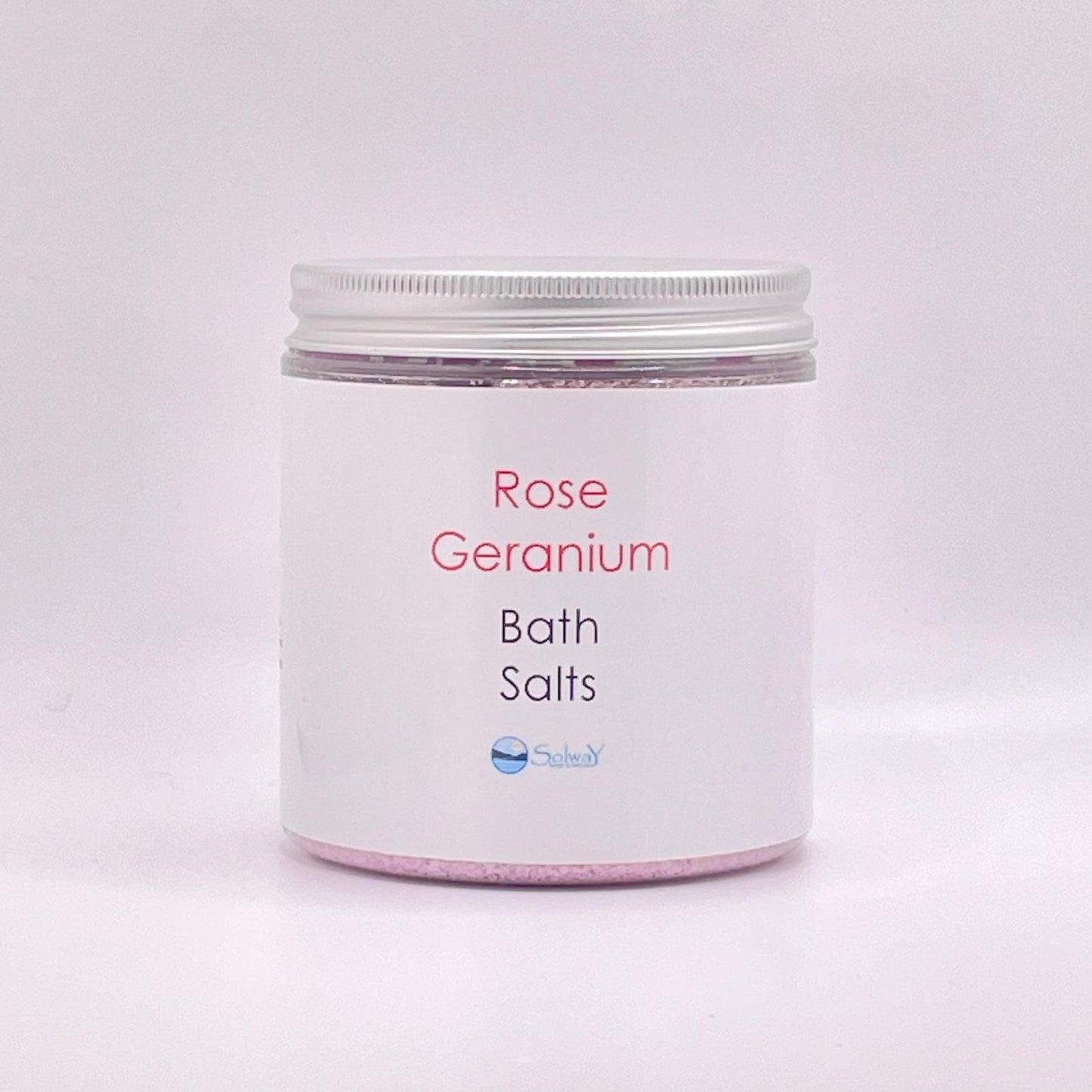 large jar of rose geranium bath salts with silver lid-pink coloured with a white label on white background