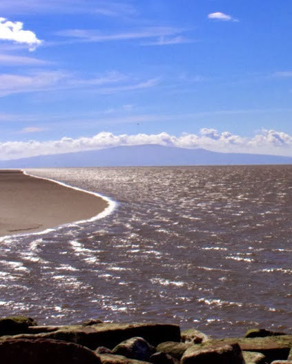 solway shore on sunny day with lake district in background