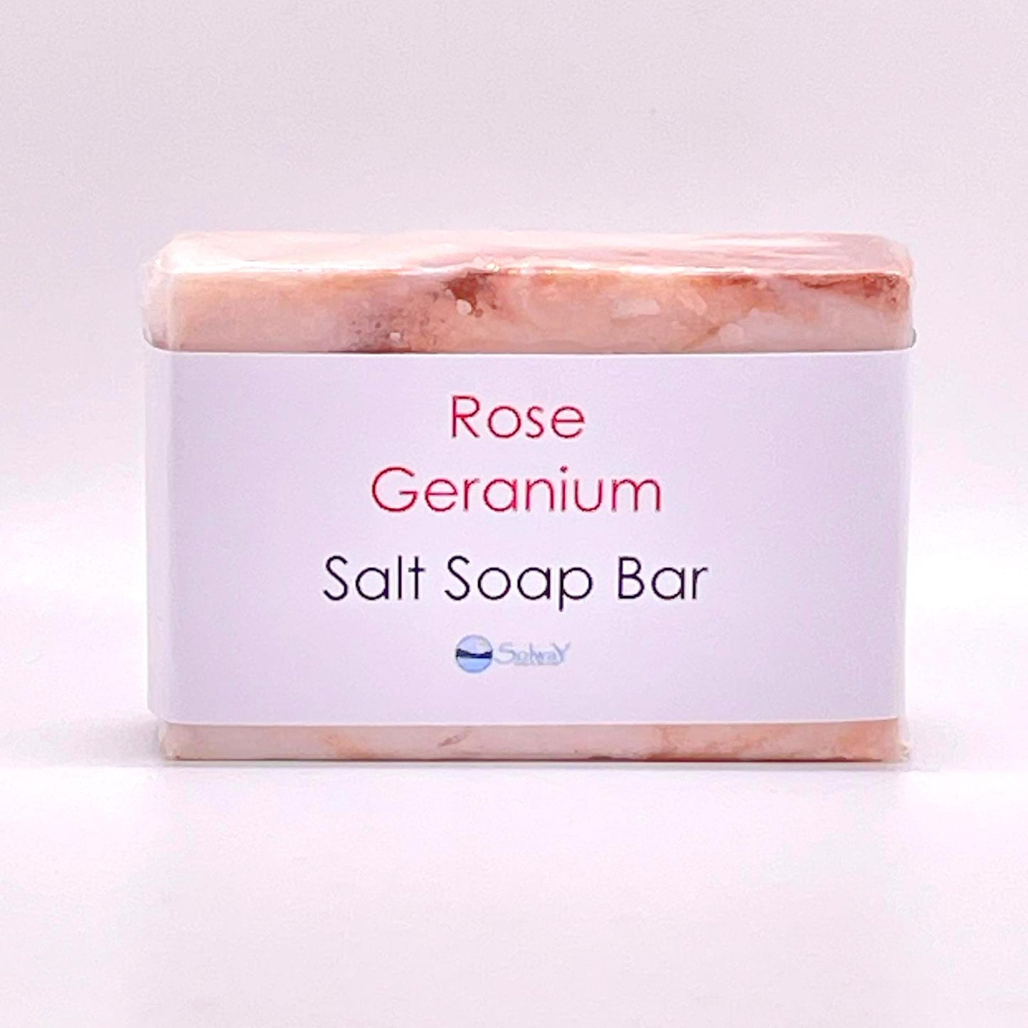 rose geranim salt soap bar wrappes in compostable cellophane with paper label. the bar is mottled red and white pattern