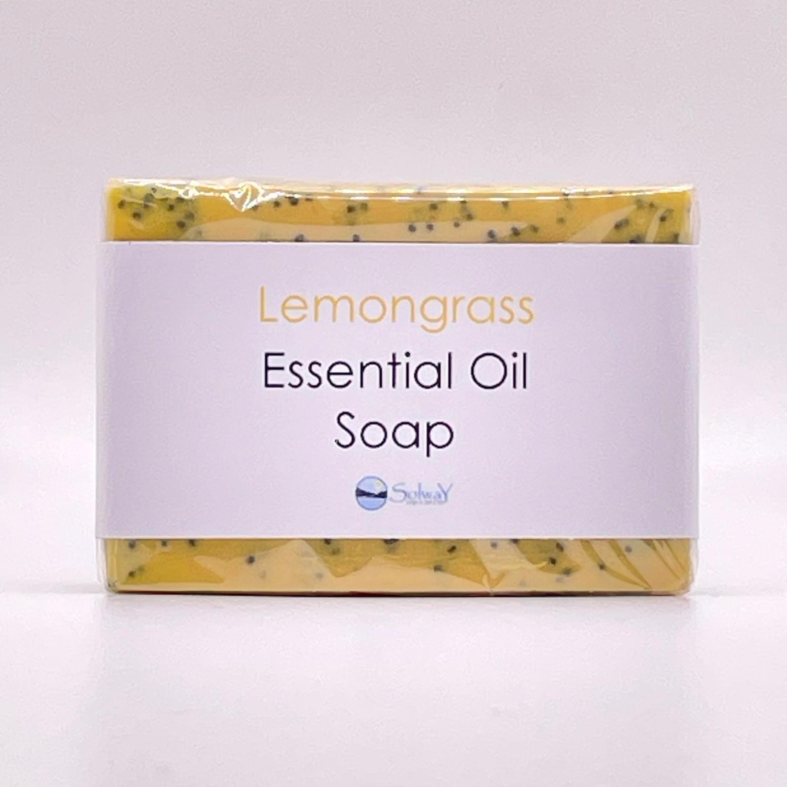 bar of natural lemongrass soap, yellow with blue poppyseeds. front view showing paper label