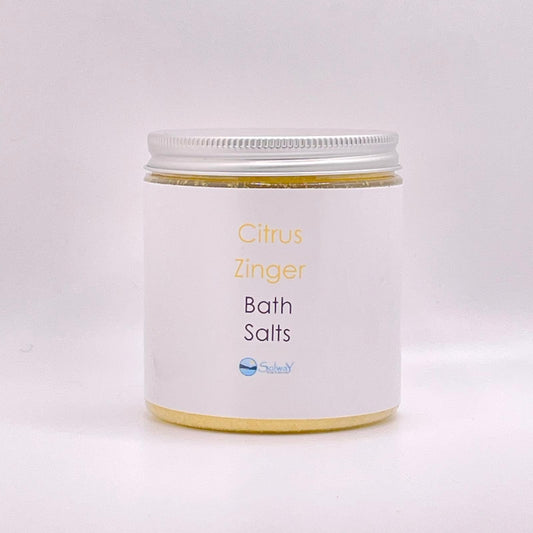 large jar of citrus zinger bath salts-Recycled PET jar with silver lid-yellow bath salts with white label-white background