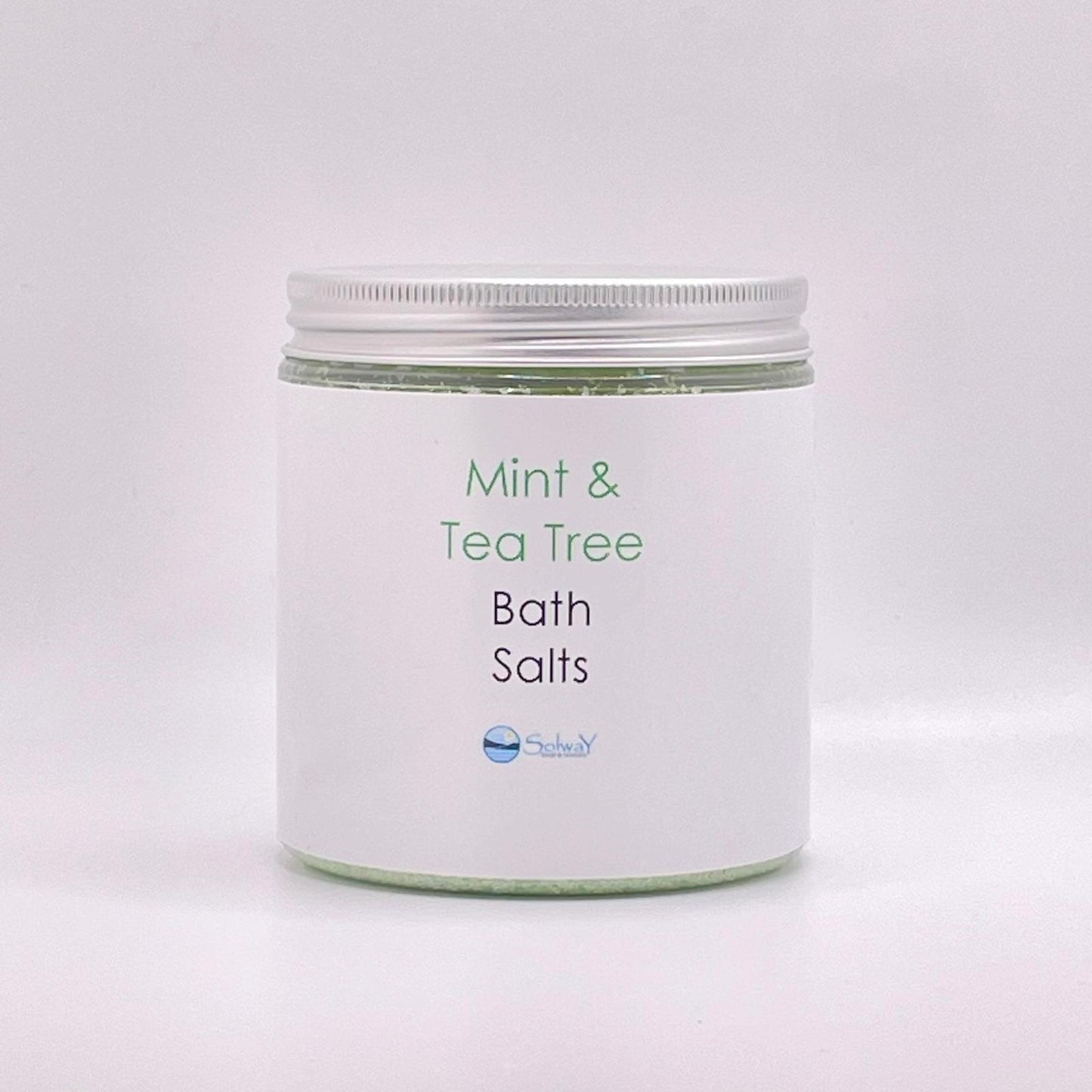 large jar with silver lid-green coloured bath salts mintt and tea tree-white label with white background.